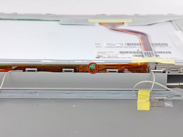 Image 1/1: Remove the 5.5 mm Phillips screw connecting the display inverter to the front display bezel.