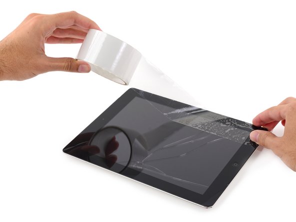 Lay overlapping strips of clear packing tape over the iPad's display until the whole face is covered.