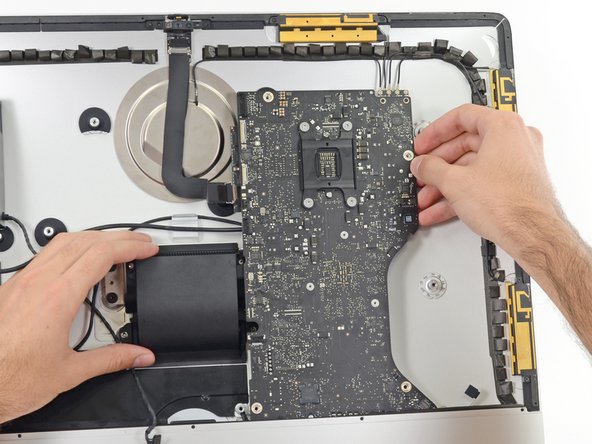 Image 1/3: Lift the logic board straight up and out of the iMac.