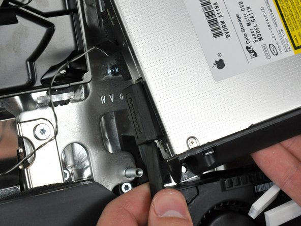 Image 1/1: Twist the spudger to slightly separate the optical drive connector from the optical drive, then use your fingers to pull the connector away from the drive.