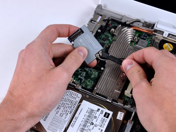 Image 1/1: Remove the AirPort/Bluetooth card from the computer.