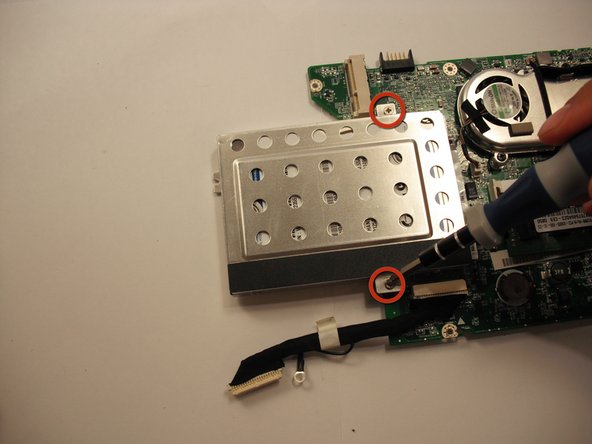 Remove the two 4.7 mm Phillips #0 screws that hold down the hard drive.