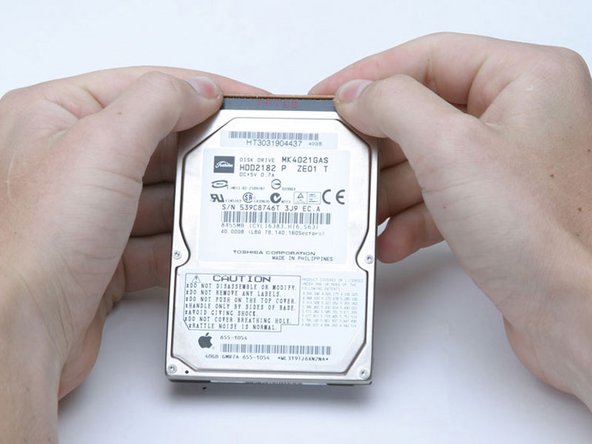 Image 1/1: This is a bit tricky. Try holding the drive against your body while pushing the cable away from you, or rocking the cable gently from side to side while applying even pressure, or both. If you bend the pins, do your best to straighten them, using the hard drive cable as a guide.