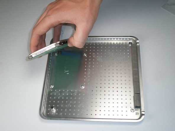 Image 1/1: The hard drive is held on to the lower case with mild adhesive.