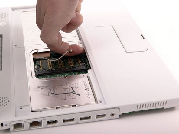 Image 1/1: Lift the upper case from the right side and use a spudger or your finger to disconnect the trackpad connector hidden beneath the white plastic tab. Due to model variatons your trackpad connector may be different from the one pictured.