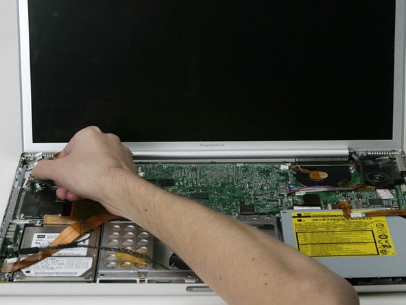 Image 1/1: If the DC-In board sticks, you may need to remove the T8 screw next to the DC-In board to free it.