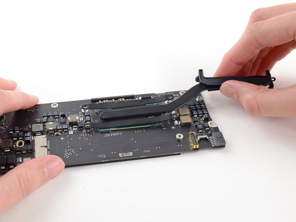 Image 1/2: Remove the heat sink from the logic board.