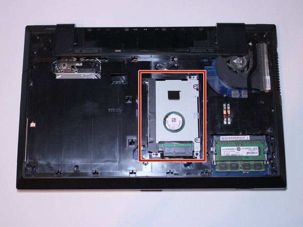 This is the hard drive. You need to remove it in order to get to the rest of the computer.