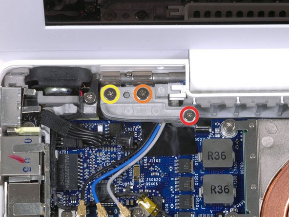 Image 1/1: Remove the following 3 screws from the left hinge mount: