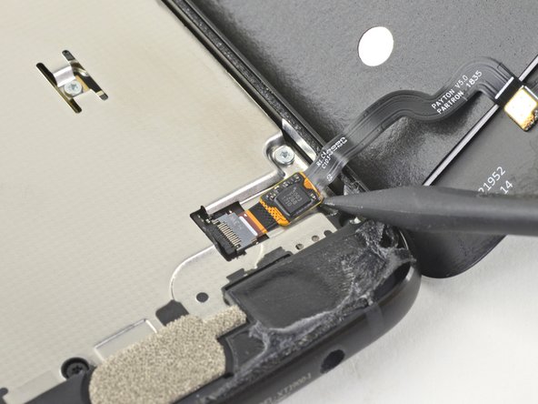 Slide the point of a spudger underneath the fingerprint sensor cable and gently pry up to loosen the cable from the phone.
