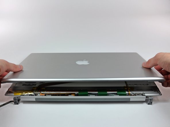 Image 1/1: Remove the rear display bezel from the display assembly.