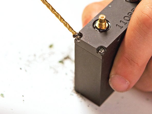 Image 2/3: The FBI really did not want anyone tampering with the innards of their tracking devices. The screws were coated with so much threadlocker that we had to break out the power drill and eliminate the screw heads.