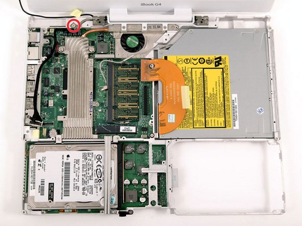Peel up the yellow tape holding the display data cable to the metal framework and remove the single Phillips screw beneath it.