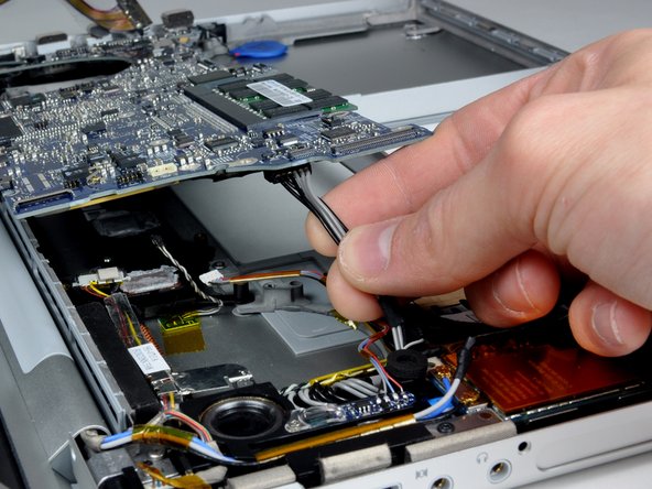 Image 1/2: Pull the power cable connector parallel to the face of the logic board.