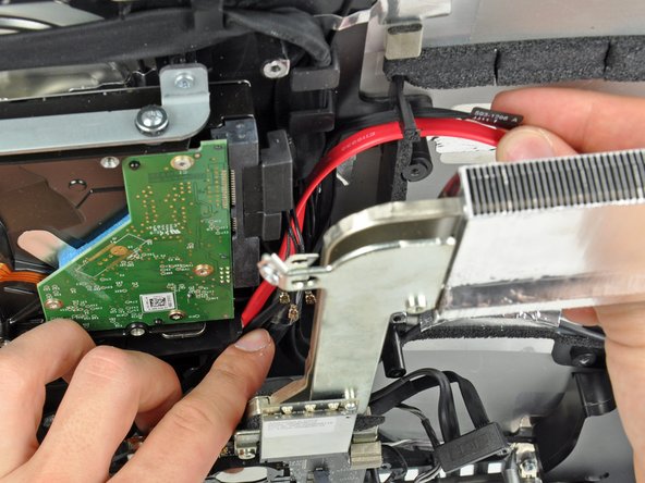 Image 1/2: When re-seating the logic board, it is helpful to tape the many connectors that attach to it out of the way to avoid them getting trapped beneath the board.