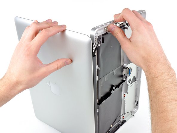 Image 2/3: Lift the display up and away from the upper case, minding any brackets or cables that may get caught.