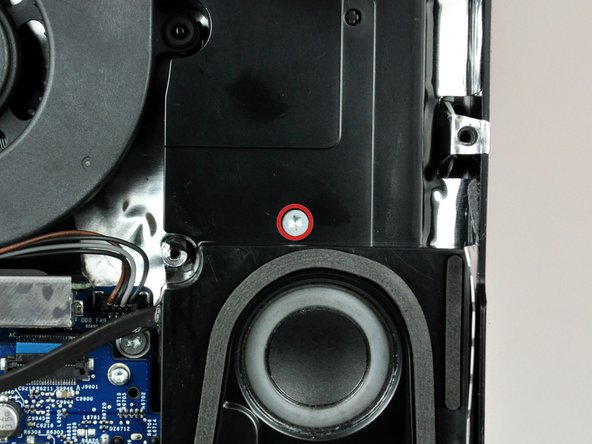 Image 1/2: Lift the right speaker up and out of the rear case, to clear the plastic mounting pins underneath it.