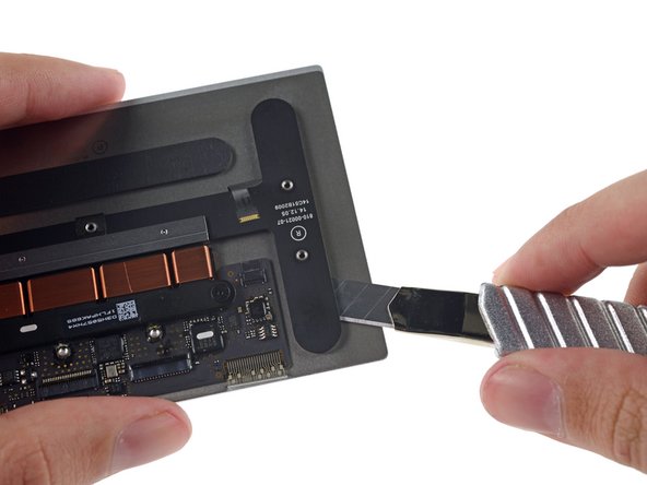 Image 2/3: Once we cut away the bracket, we get a clear view of the Taptic Engine.