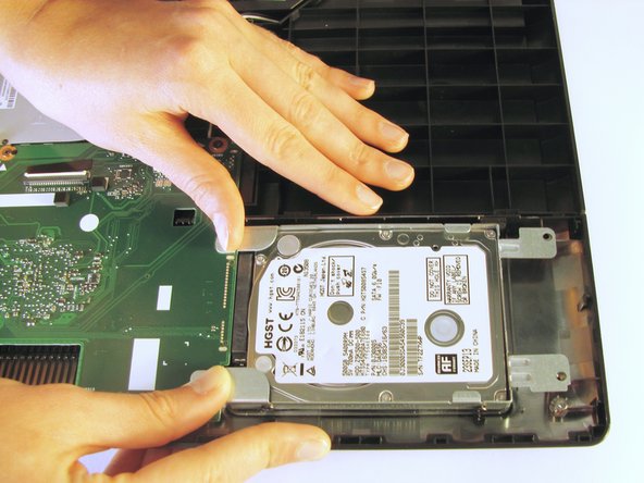 Once the screws have been removed, place your fingers on the left corners and push the hard drive towards the right edge of the laptop (relative to the picture).