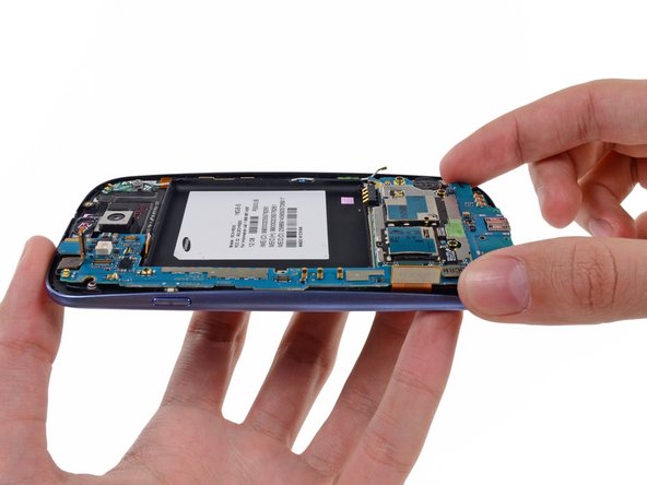 Image 1/2: Carefully lift the bottom of the motherboard assembly away from the front panel assembly.
