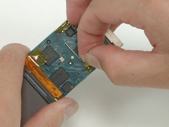 Peel up the orange tape covering the three solder points on the other side of the logic board.