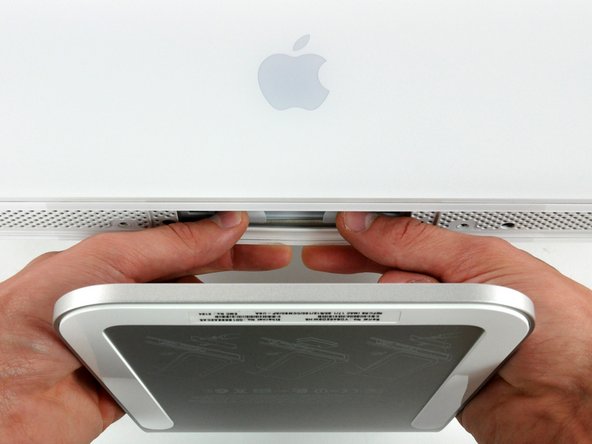 Image 1/2: To lift the front bezel off the iMac, simultaneously: