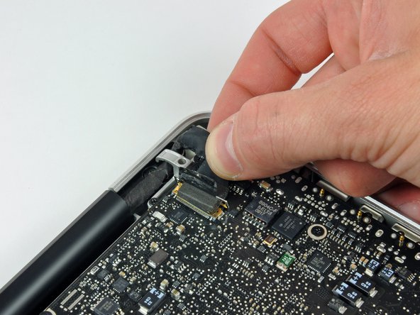 Image 3/3: Pull the display data cable connector straight away from its socket, towards the DC-in side of the computer.