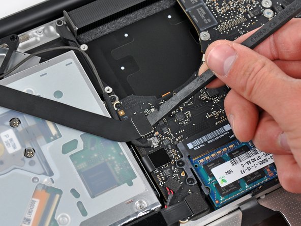 Image 1/1: Fold the AirPort / Bluetooth ribbon cable back to keep it out of the way of the logic board.