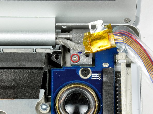 Image 1/1: One 9.5 mm silver T6 Torx screw with threads on only 3 mm of the shaft on the inside of the display hinges.