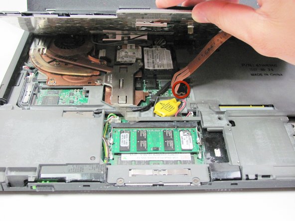 Image 2/2: Lift the keyboard until you are able to see the wire connection