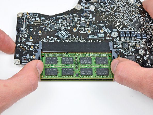 Image 1/2: These tabs lock the chip in place and releasing them will cause the chip to "pop" up.