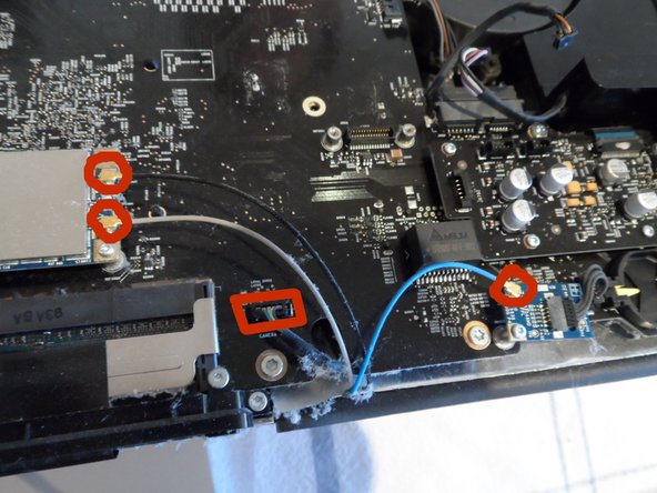 Image 2/3: At last you'll disconnect the main power cord and the Hard Drive SATA cable. I photographed the top one already disconnected; be sure to squeeze the edge tabs to release the clamp hooks. The HDD SATA connector has a convenient pull tab.