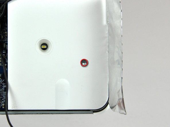 Image 1/2: Lift the right speaker out of the rear case and move it out of the way.