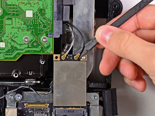 Image 1/2: The gray antenna attaches to the socket on the left and the black antenna attaches to the socket on the right.