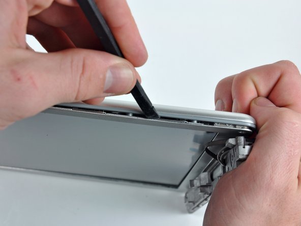 Image 1/2: Rotate the tool away from the LCD to pop the rear bezel off the tabs on the front display bezel.