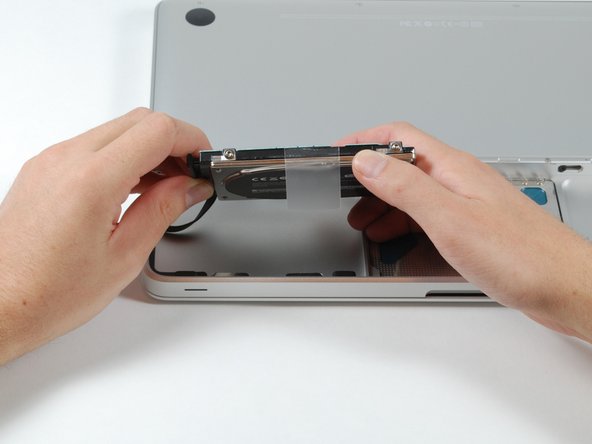 Image 1/1: To replace the hard drive, you'll need a T6 Torx screwdriver to transfer the hard drive mounting screws to the new drive.