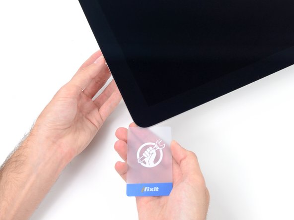 Image 1/3: Set the iMac face-up on a table.