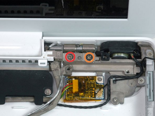 Remove the following 2 screws from the right hinge mount: