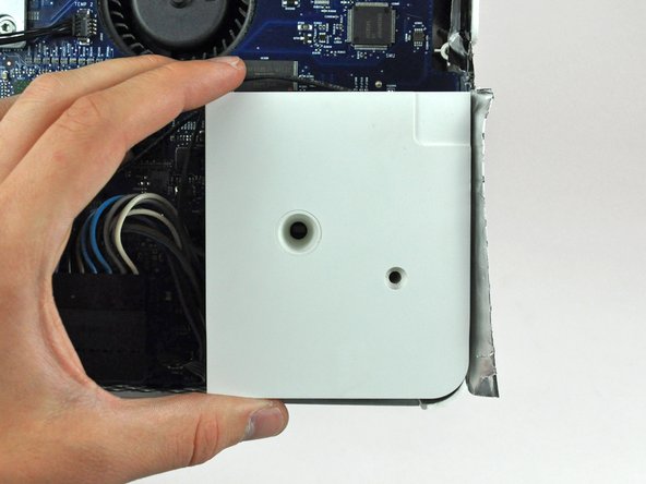 Image 2/2: Lift the right speaker out of the rear case, minding the short cable between the speaker and its connector (located slightly above the right speaker).