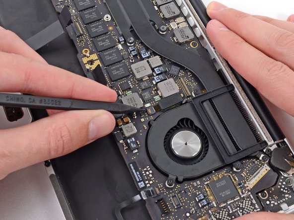 Image 2/3: Carefully pull the left fan ribbon cable out of its socket.