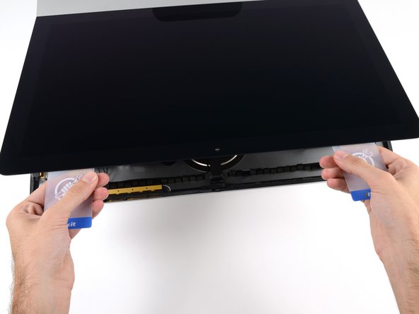 Image 3/3: Only lift the display a few inches—the display data and power cables are still connected to the logic board.