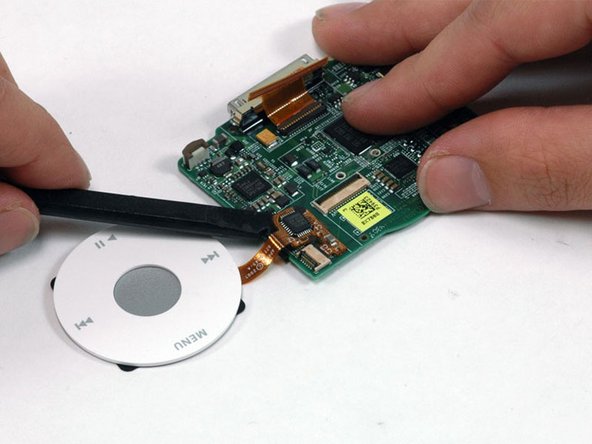 Image 1/1: When reinstalling the clickwheel, make sure that the click wheel cable is pushed all the way into its connector.
