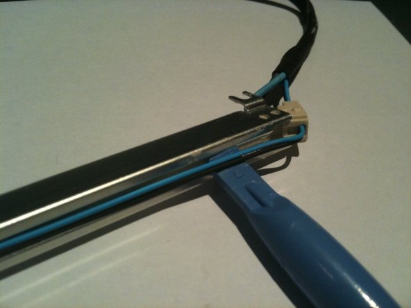 Image 1/3: Using a plastic pry tool you can pop the rubber end cap out and then lift the thin wires out of the groove in the rear of the CCFL assembly