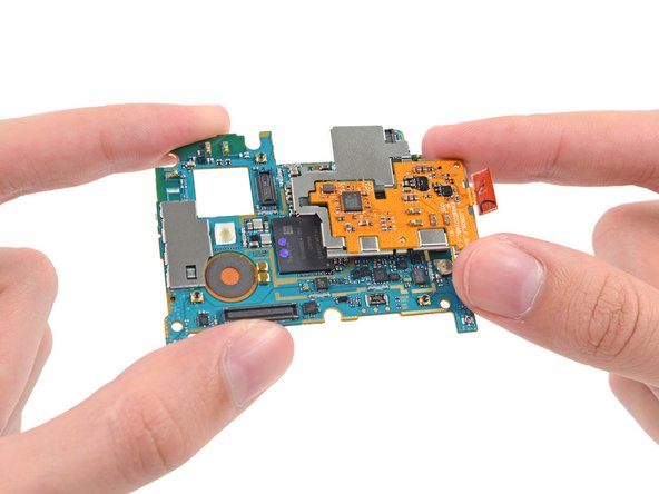 We quickly spudge away the wireless charging control and NFC board. LG built this little board into an EMI shield assembly that pops in right over the motherboard.