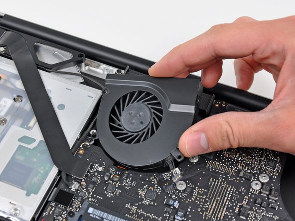 Image 2/2: Remove the right fan from the upper case.