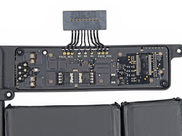 Image 2/3: With the battery free, we finally get a better look at the connector.