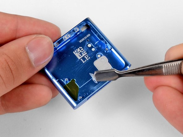 Recruiting the help of our spudger and our precision tweezer set, we remove the remaining gallons of glue from inside the nano's case.