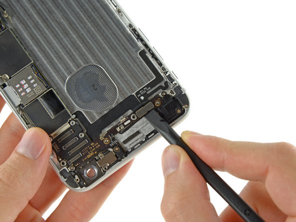 Image 1/2: Disconnect the power button cable and audio control cable connectors from their respective sockets on the logic board.