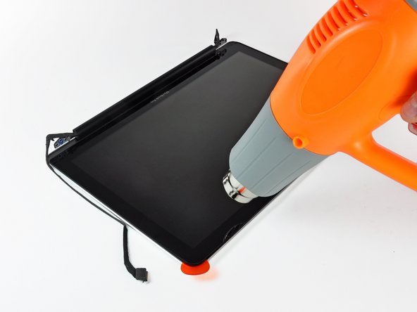 Image 1/2: Attach a suction cup near the top edge of the glass display panel and use it to pull the glass panel up off the display.