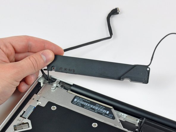 Image 2/2: Lift the subwoofer off the optical drive, and set it above the computer.